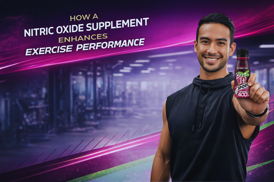 A smiling athlete in a gym holding a Beet It Sport Nitrate 400 shot to demonstrate how a nitric oxide supplement enhances exercise performance.