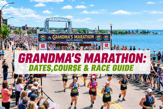 Grandma's Marathon finish line in Duluth with runners, crowds, Lake Superior and the Aerial Lift Bridge on a sunny day.