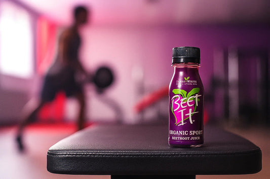 When to Take Nitric Oxide — Beet It Organic Beetroot Juice nitrate shot bottle on gym bench in focus"