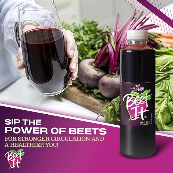 A person holding a glass of BEET IT Organic Beetroot Juice 25.4 fl oz next to fresh whole beets to promote stronger circulation.